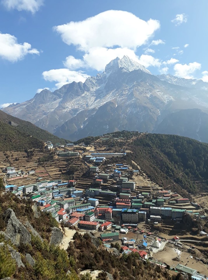  bustling Namche Bazaar, a charming mountain town surrounded by stunning peaks and vibrant culture.